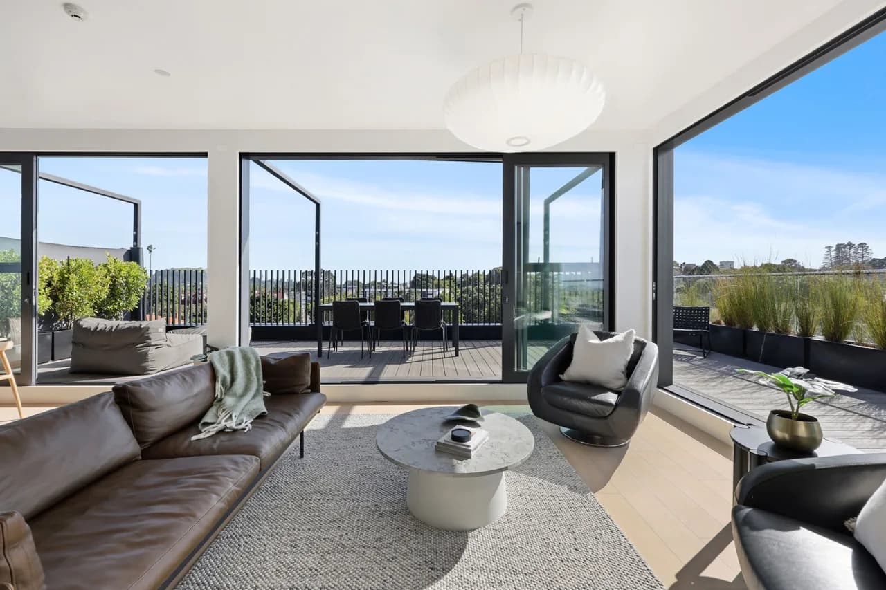 The living room of Penthouse 505 opening onto the wraparound terrace