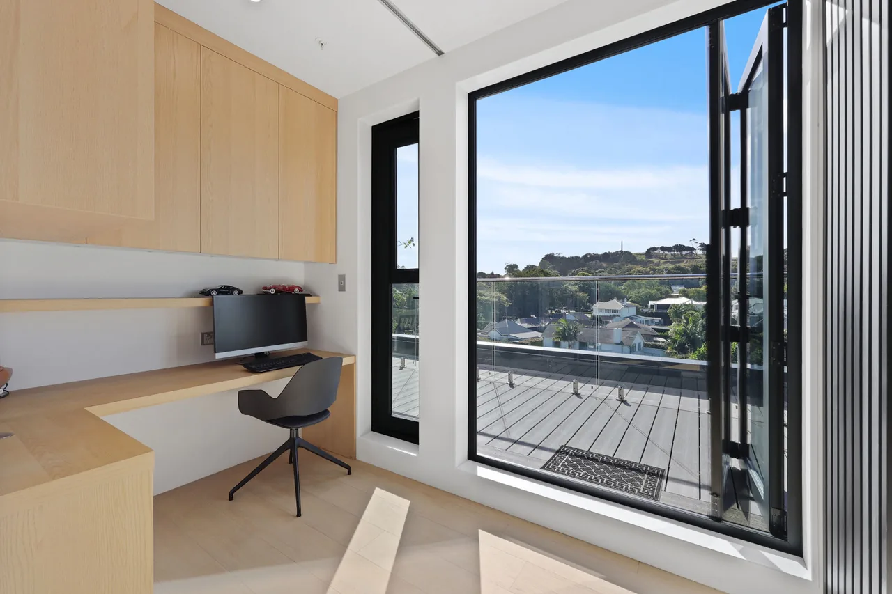 A study at Penthouse 505, built-in oak desk looking out to the terrace