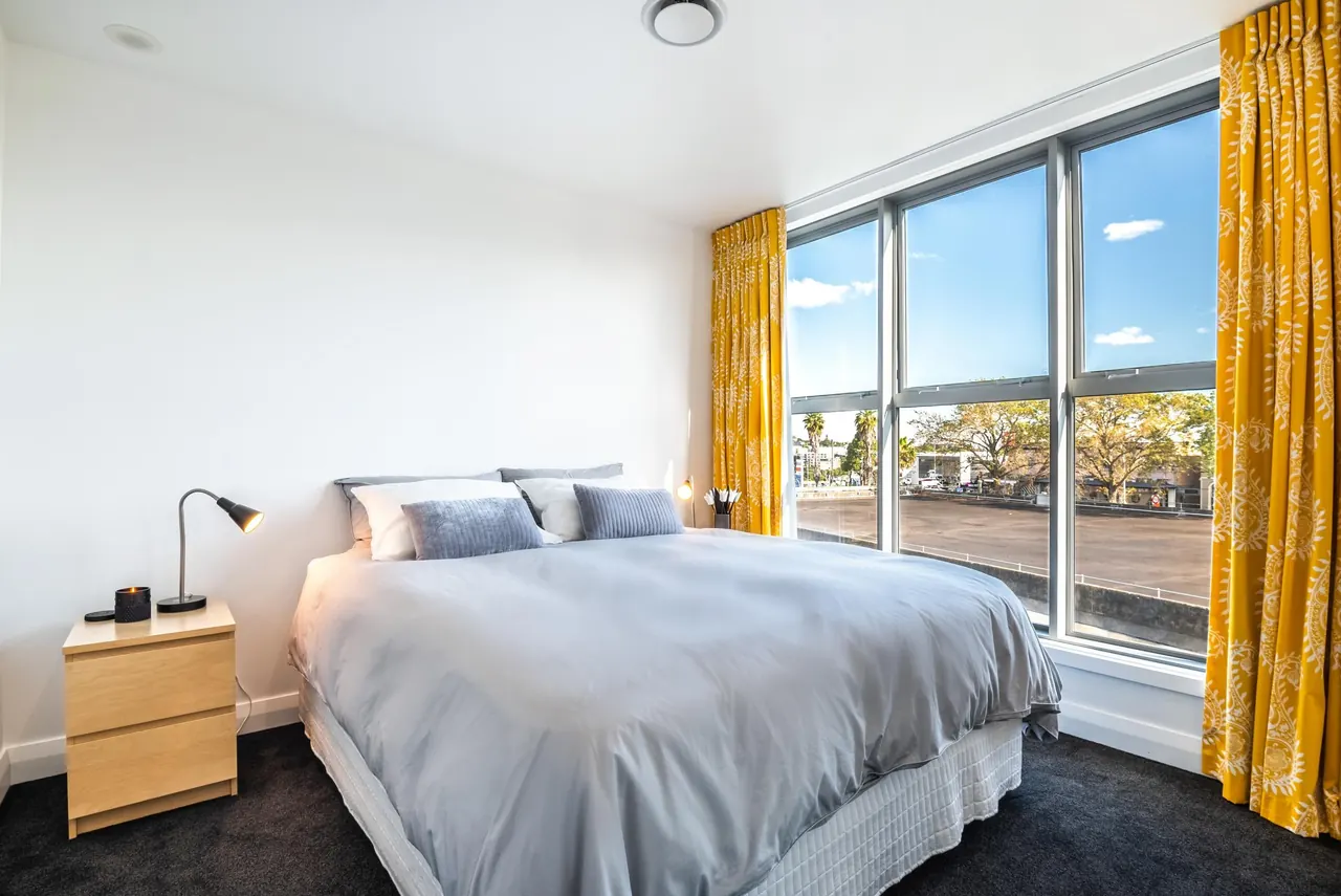 Another of the downstairs bedrooms, with full-height windows