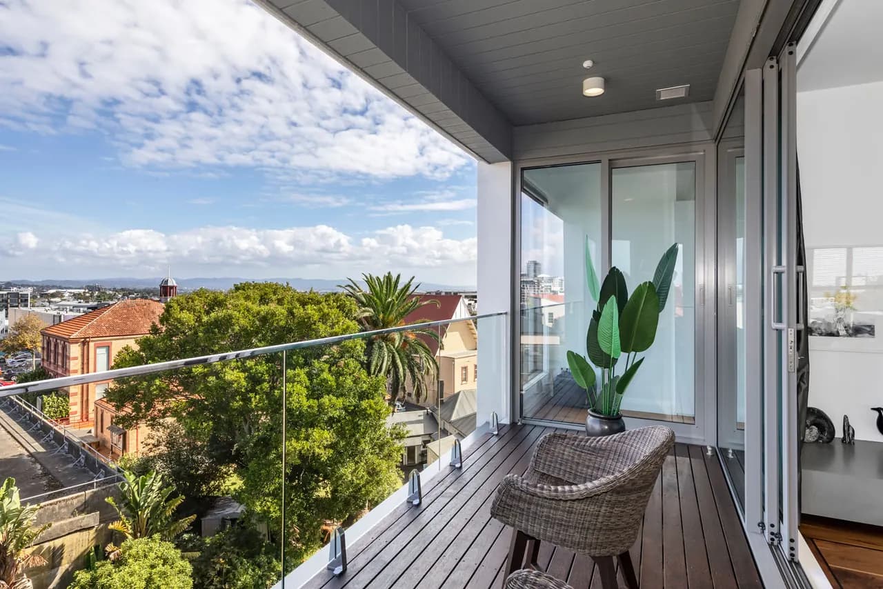 The deck of Penthouse 504 by day, looking out over the treetops
