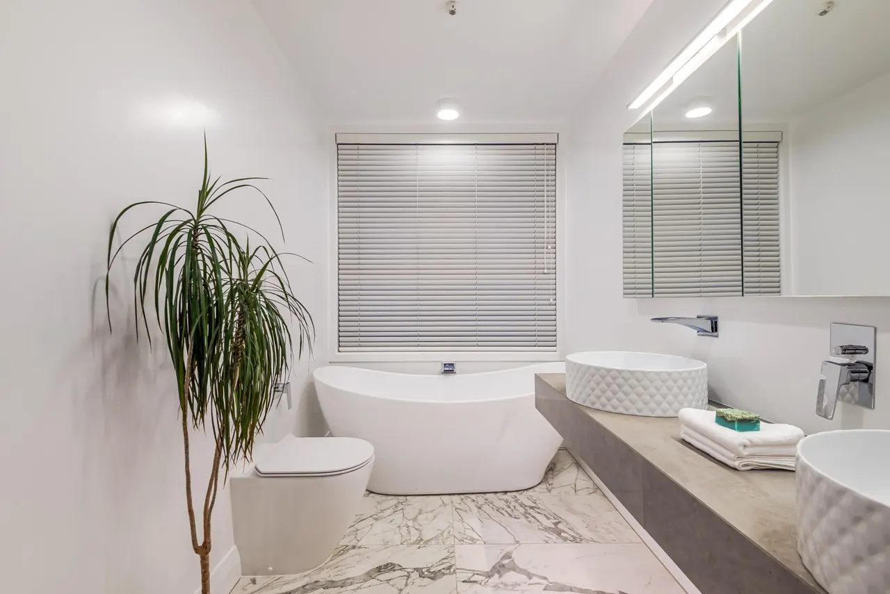 The ensuite, with a full-size freestanding bath and double basins