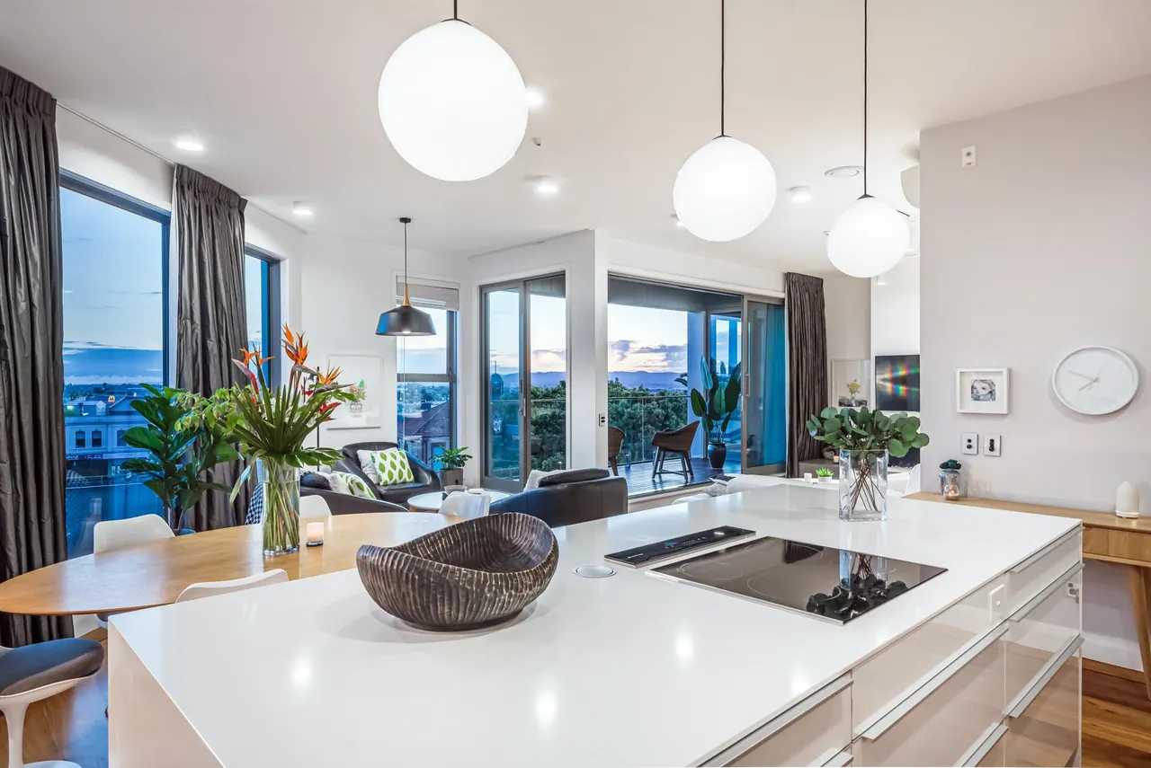 The kitchen island and dining area, with floor-to-ceiling windows behind