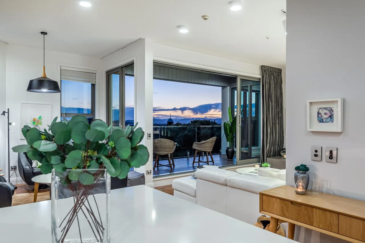 From the kitchen island through the living room to the deck at dusk