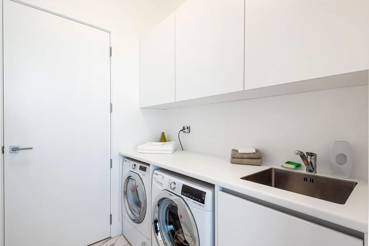 One of the two full laundries, with cupboards above