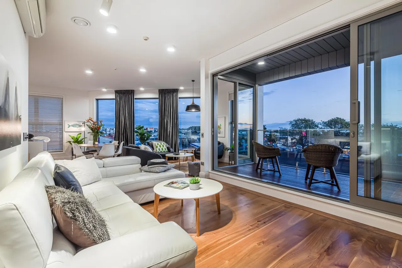 Upstairs living room flowing through to the dining area and deck