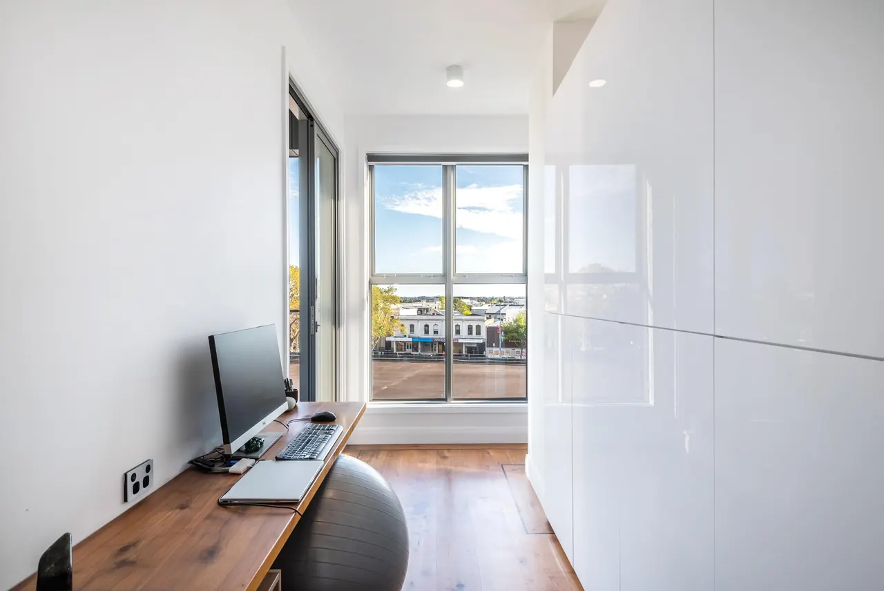 The office for two, with its full wall of cupboards