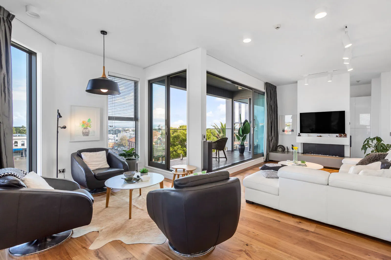 Living room of Penthouse 504 at Western Park, corner glazing opening to the deck